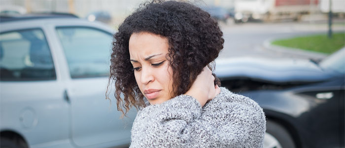 woman holding her neck after an auto accident